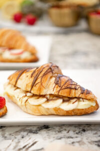 Banana cream filled croissant drizzled with chocolate